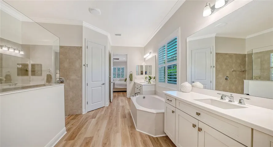 Primary ensuite bathroom with dual vanities