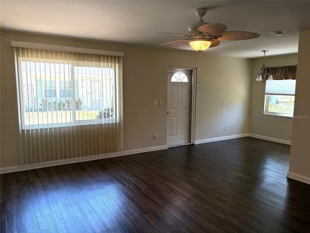 Living room toward front entrance.  Vertical blinds let you filter in just the right amount of light.