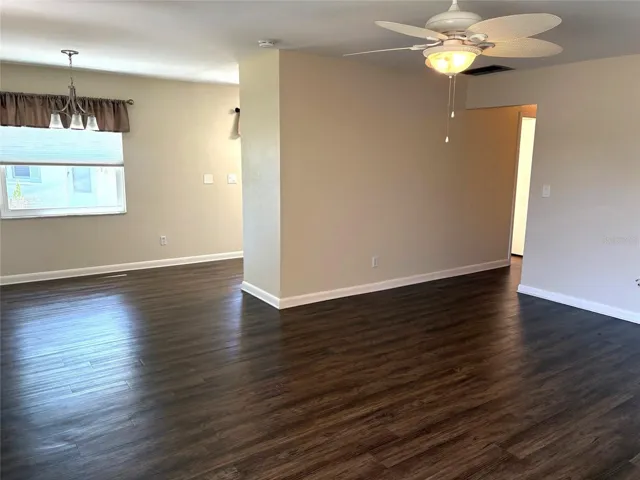 Living room toward dining area, with beautiful natural light.