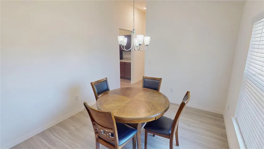 The separate dining area offers a comfortable space for everyday meals or more formal gatherings, with direct serving access from the kitchen that makes entertaining easy and convenient.