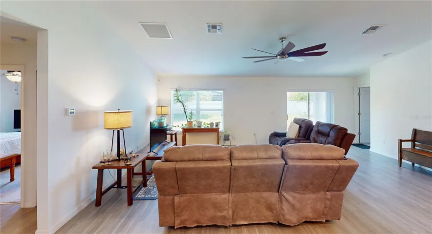 View from the guest suite shows the open, airy living area with plenty of space to spread out—plus easy sightlines to the lanai slider for smooth indoor-outdoor flow.