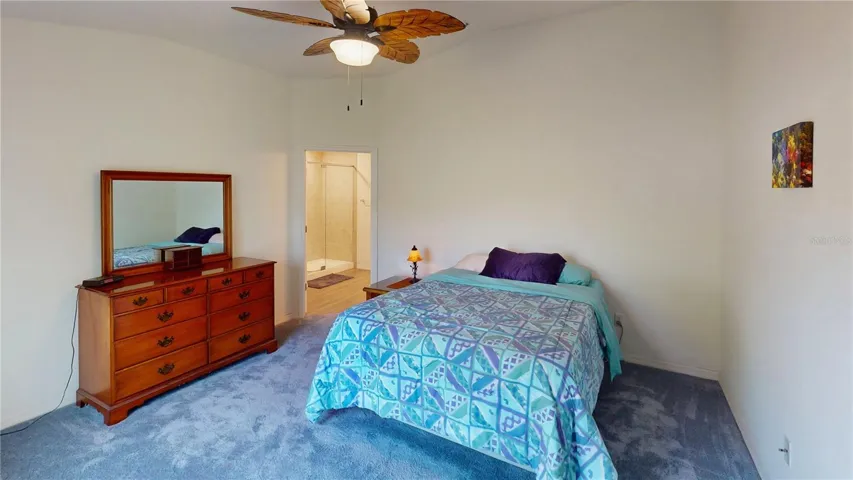 Relaxing primary suite with a ceiling fan, walk-in closet, and private ensuite bath—a comfortable retreat with a clean layout and great everyday functionality.