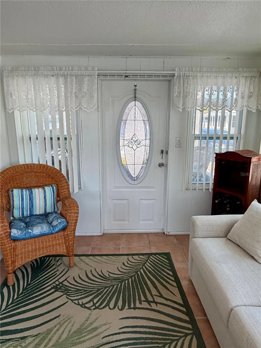 Bonus room has ceramic tile, and does open up to the front screen porch.