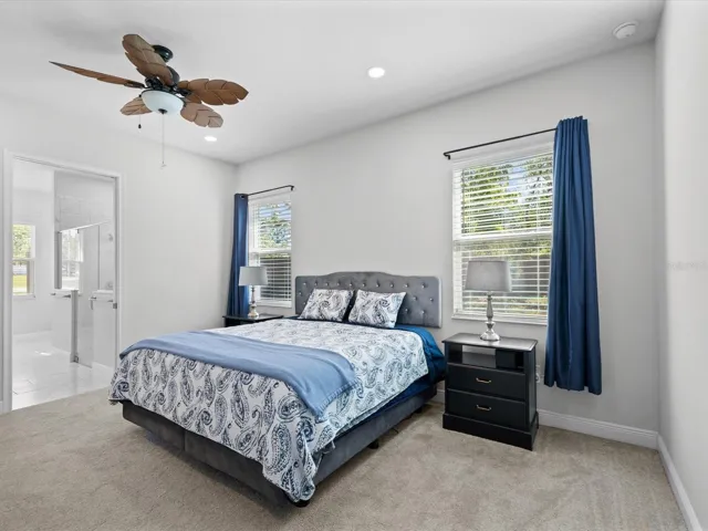 The primary suite offers a generous en-suite bath and an adjacent flex room—perfect for a zen retreat, home office, or additional bedroom