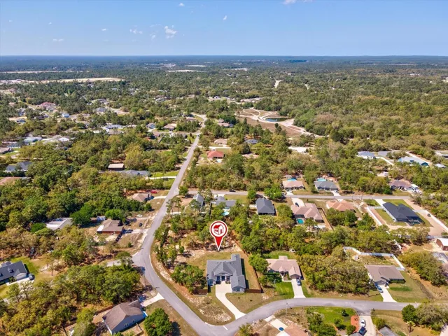 An extra-tall fenced backyard with multiple gates, offering exceptional privacy and versatility