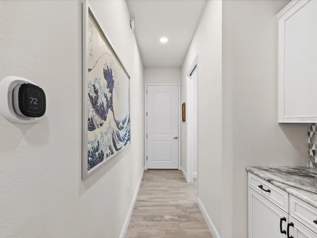 “A thoughtfully designed drop-zone desk and hallway connecting seamlessly from the garage