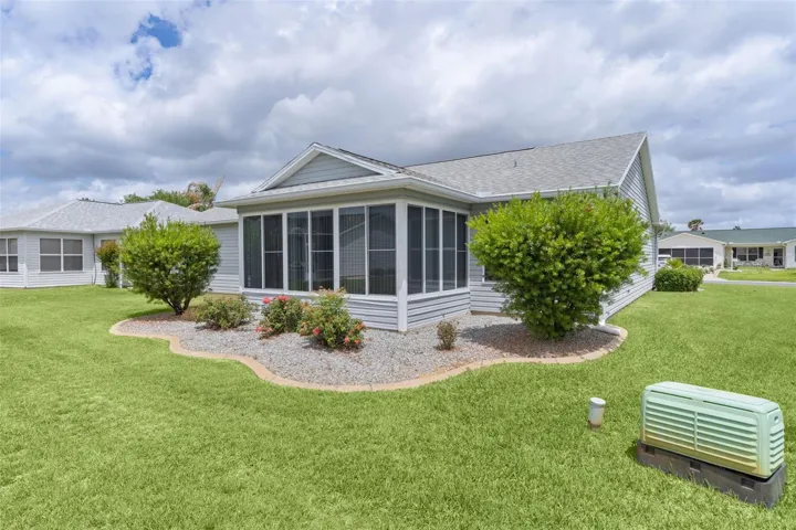 BACK OF HOME, LANDSCAPED, LANAI WITH SCREENS WHEN WINDOWS ARE OPEN
