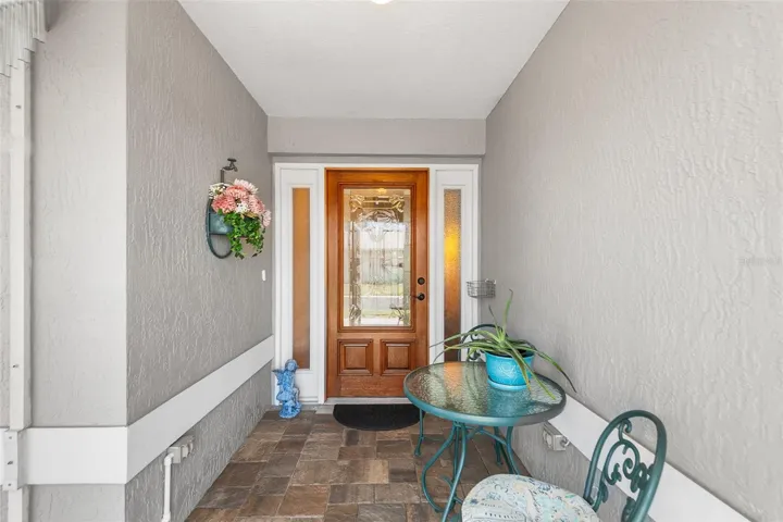 SCREENED FRONT ENTRY. GORGEOUS LEADED & BEVELED GLASS FRONT DOOR!