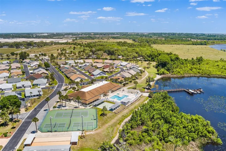 AERIAL VIEW OF CLUBHOUSE, BOCCE BALL, TENNIS, PICKLEBALL & SHUFFLEBOARD COURTS PLUS POOL & DOCK