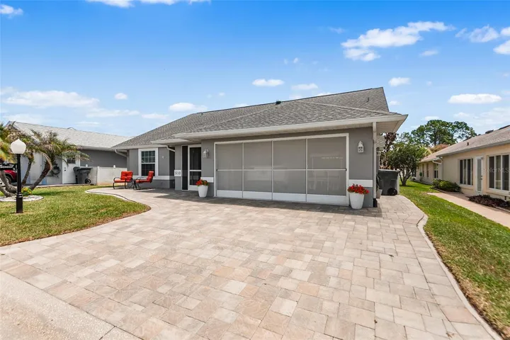 EXTERIOR FRONT. NOTE WIDE PAVER DRIVEWAY & PATIO AREA!