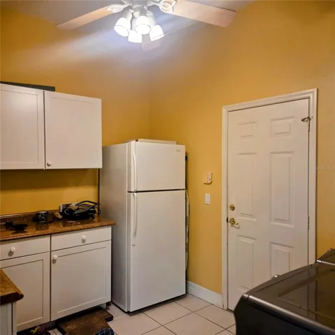Large laundry room with storage, extra refrigerator