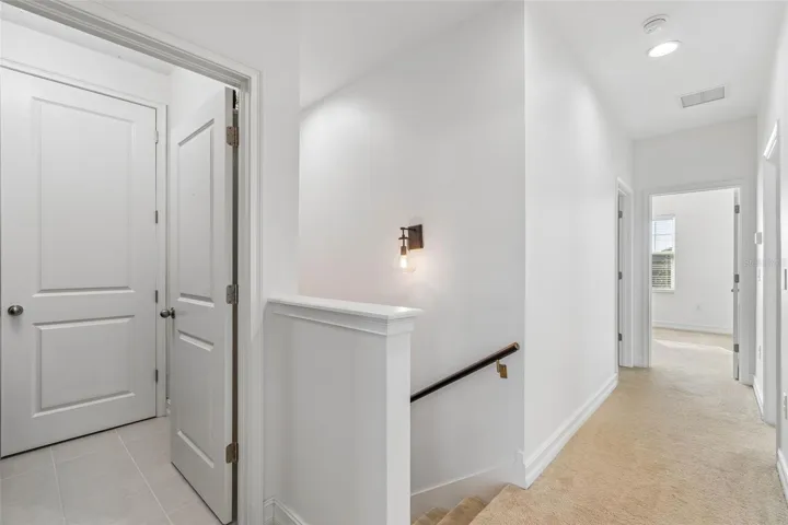 View from Primary bedroom down hallway & laundry room