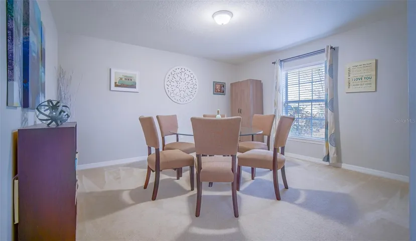 Flex area by the main entrance --> Possible Formal dinning area, Gathering room, Office area, etc -- Old photo with carpet