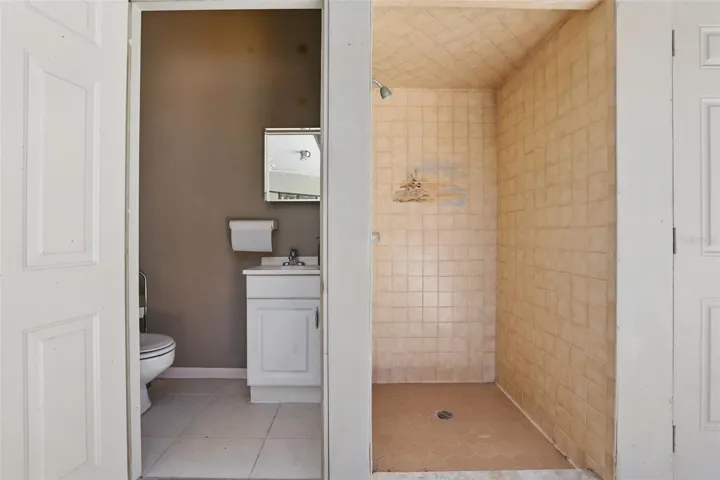 Half bathroom and walk in shower by the pool