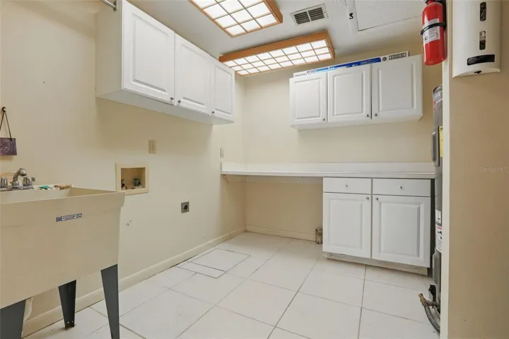 Laundry Room with cabinets and sink