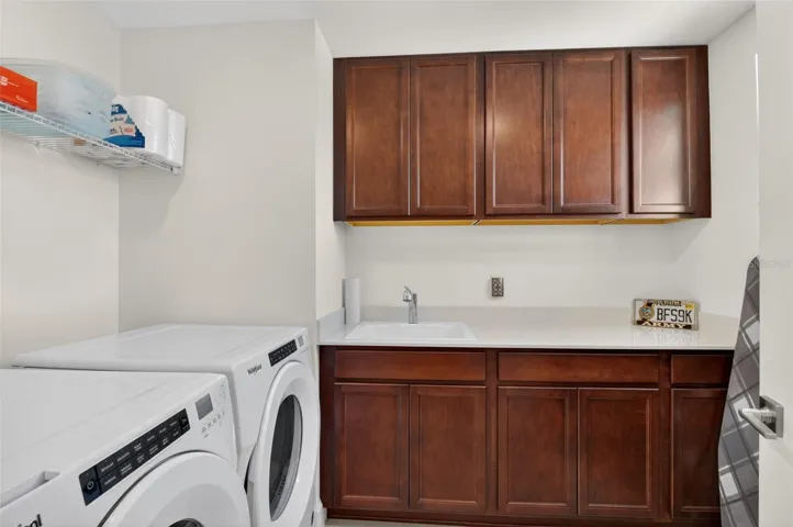 Laundry area with upgraded built in cabinets and laundry sink