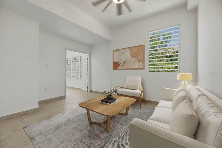 Primary Suite's Sitting Area - This image has been virtually staged and does not reflect the current state of the property.