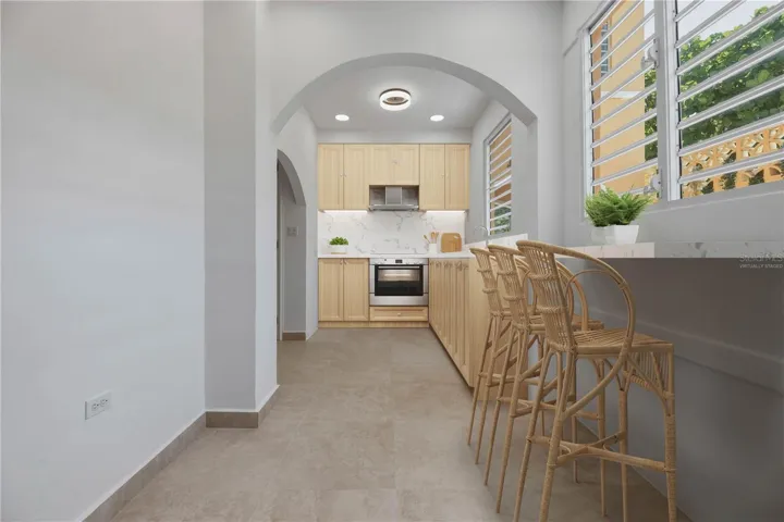 Eat-In Kitchen - This image has been virtually staged, including kitchen cabinetry/appliances and breakfast nook. The photo does not reflect the current state of the property.