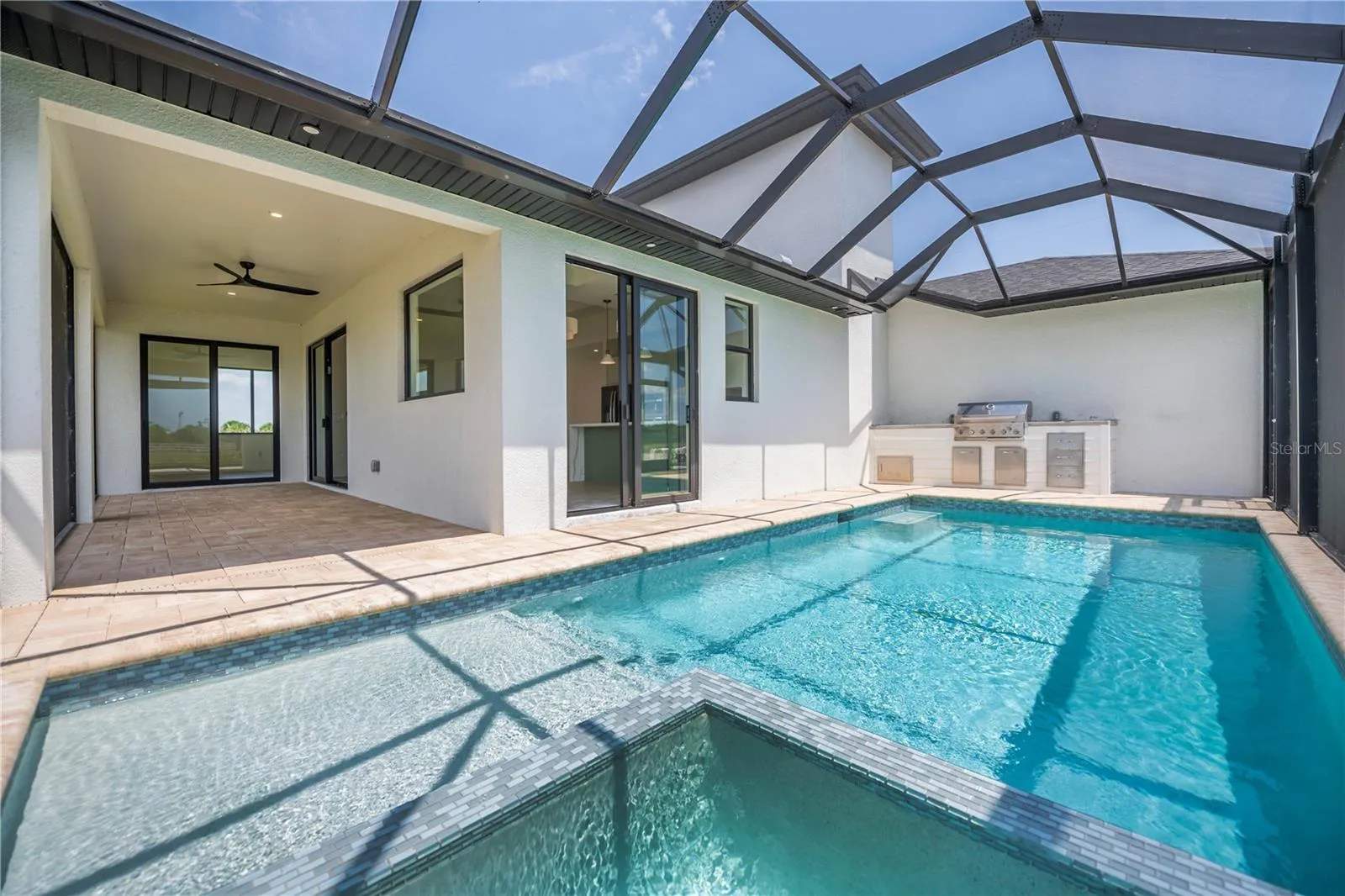 Modern Pool with Built in Jacuzzi and Outdoor Kitchen