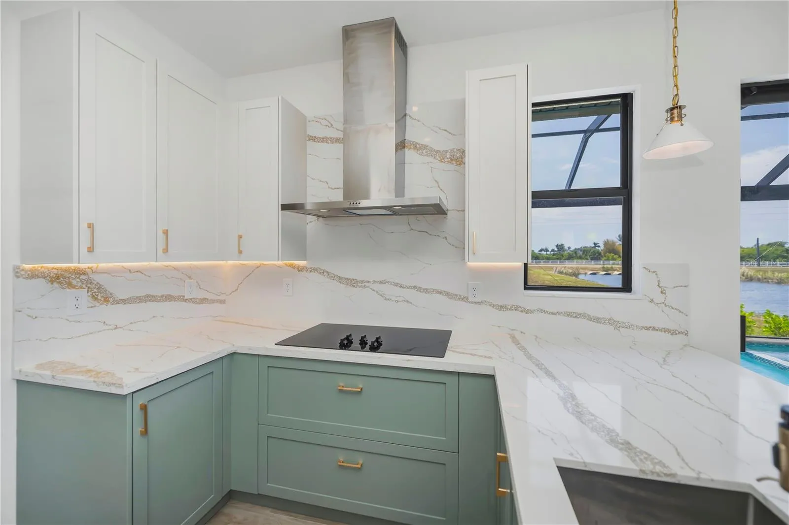 Quartz Counters, Backsplash, Custom Lighting and Coastal Cabinetry.