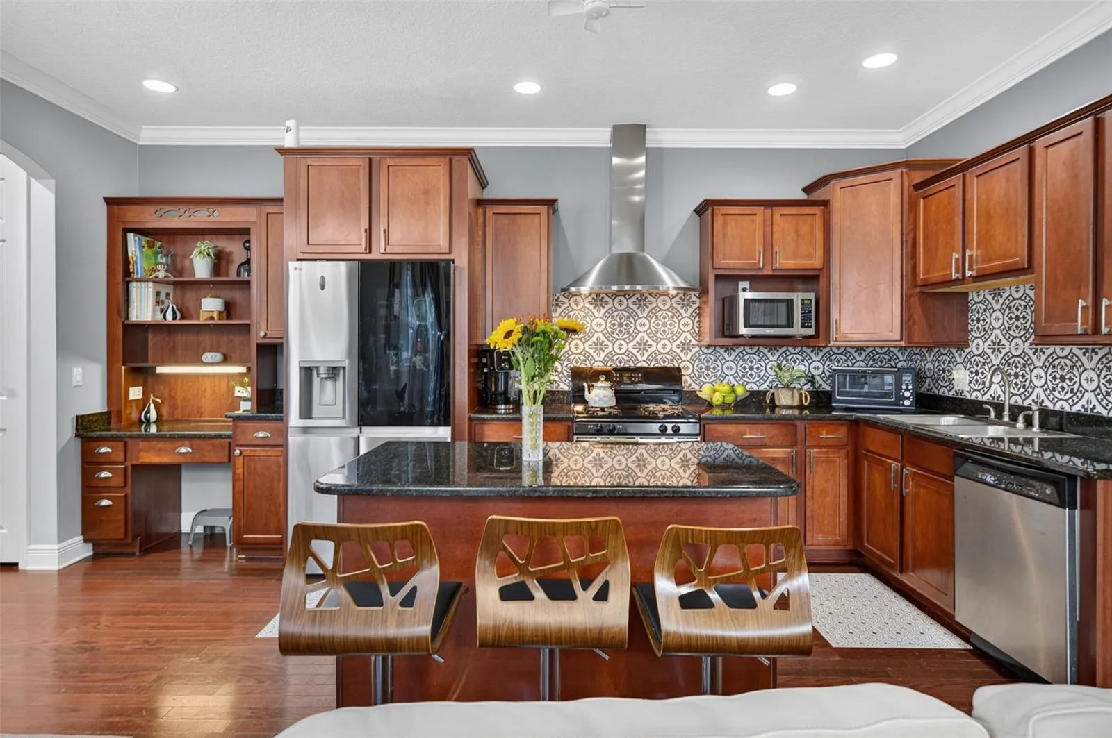 Kitchen with hood, cabinets and granite counters