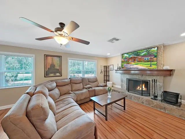 Warm & inviting living room centered around a beautiful stone fireplace with mantle & hearth. Plenty of natural light through newer windows - a space you'll never want to leave!