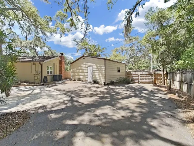 Rear entry of the detached 2-Car Garage, plus the adjacent paved spot specifically designed for RV storage (with 50-amp plug service for hooking up).
