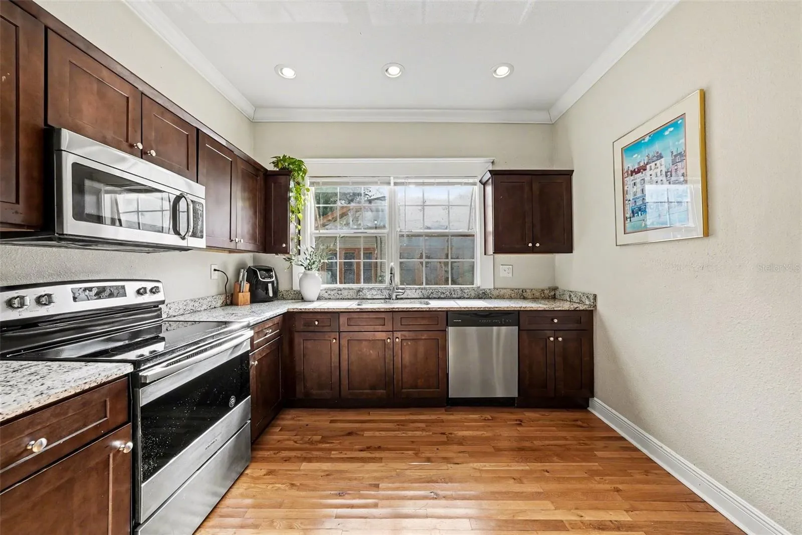 Kitchen with solid wood cabinetry, stainless appliances, and ample counter space.