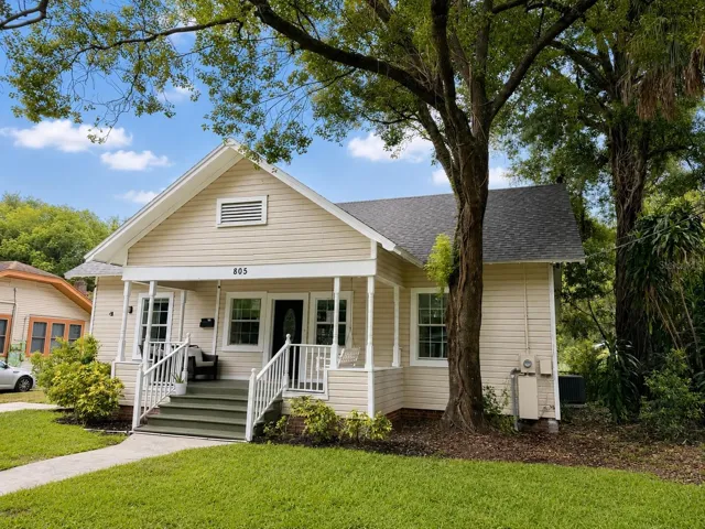 Front exterior with classic bungalow charm and mature landscaping.
