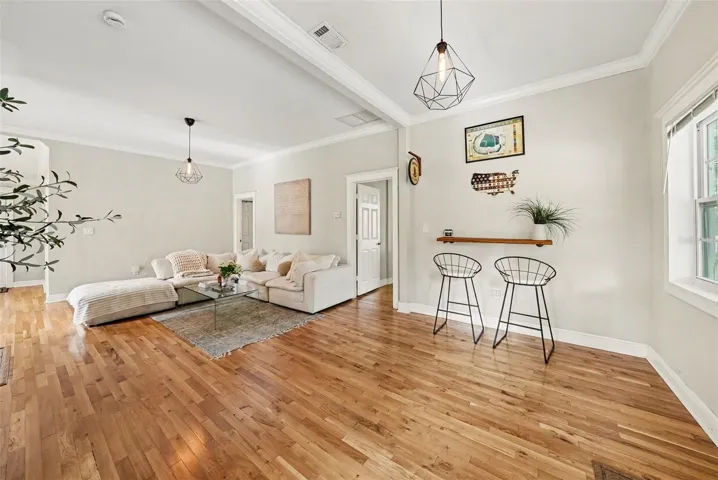 Living space with decorative fireplace and flexible seating arrangement.