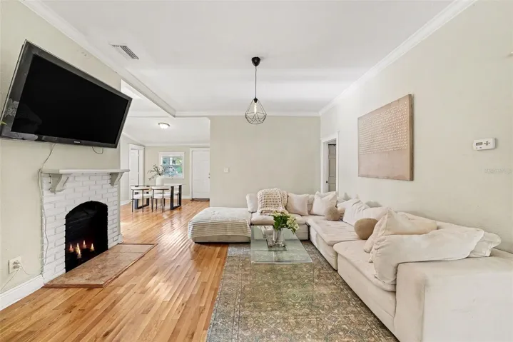Main living area with wood flooring and open layout.