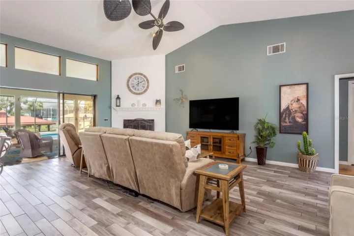Living room with 3 sliders that ead to Screened in Lanai.