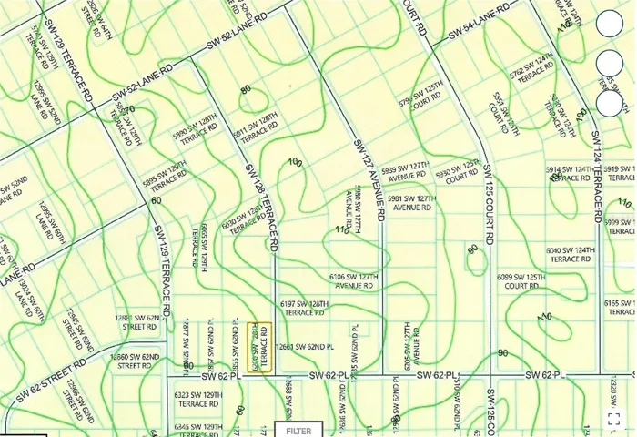 Corner of paved SW 62nd Pl and 128th Ter Rd dirt