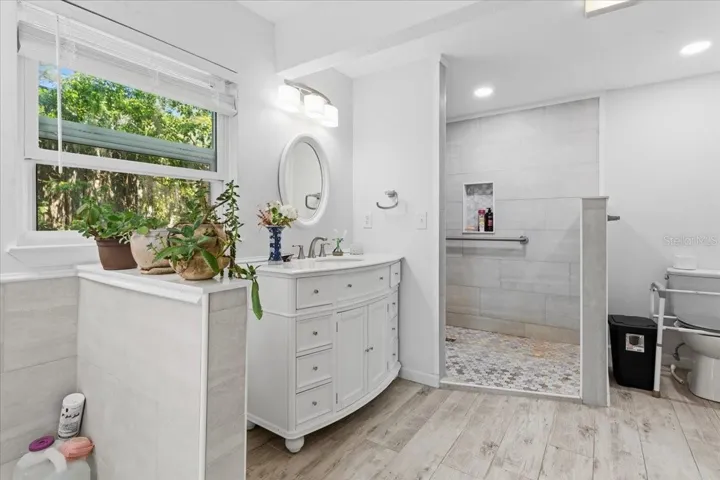 A step in shower with grab-bars installed for safety