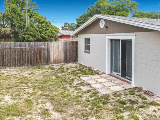 view of sliding door and side patio to main bedroom