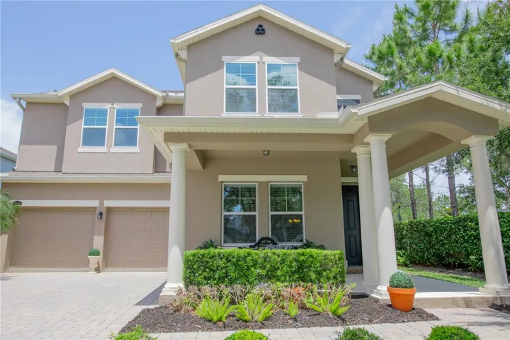 2 car garage, covered front porch & entry and rain gutters. Green space to the right of the home.