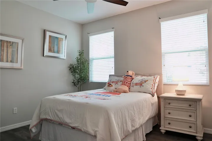 Bedroom 3 with ceiling fan and luxury vinyl plank flooring.