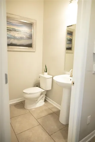 Half bath located in the hallway leading to the 2 car garage.