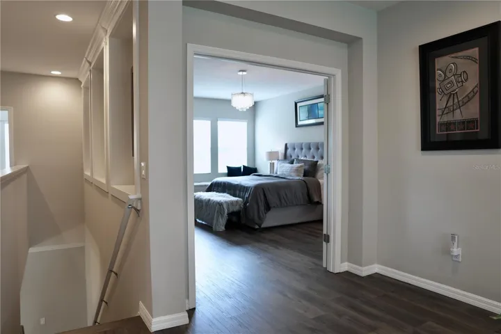 Double doors to the right of the stairs, lead to the primary bedroom.