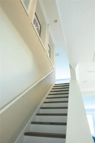 Stairs with LVP treads and painted risers, are adjacent to the dining room. Stairway has decorative niches.
