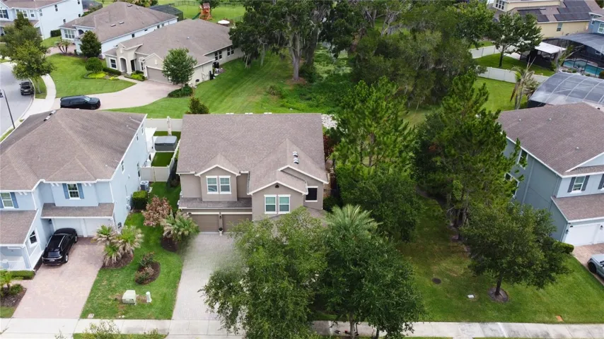 Conservation lot situated on an inlet off of Lake Burnett, with a green space to the right of the home.