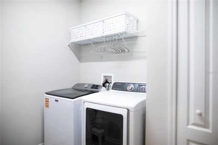 Laundry room with linen closet. The washer and dryer are included.