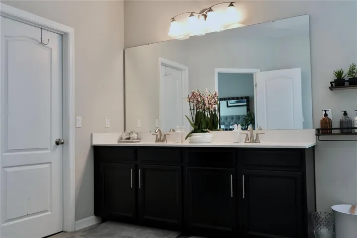 Walk-in closet through the door on the left of the vanity.