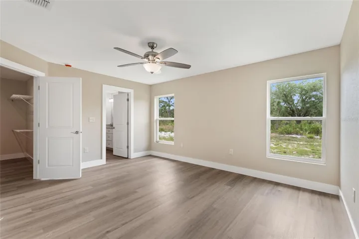 The primary bedroom suite has a large walk-in closet, double sink vanity, shower, and linen closet.