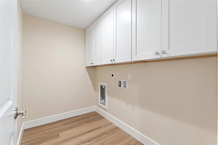 The laundry room is enclosed.  Yay!  located just off the primary suite.  There is lots of room for storage.