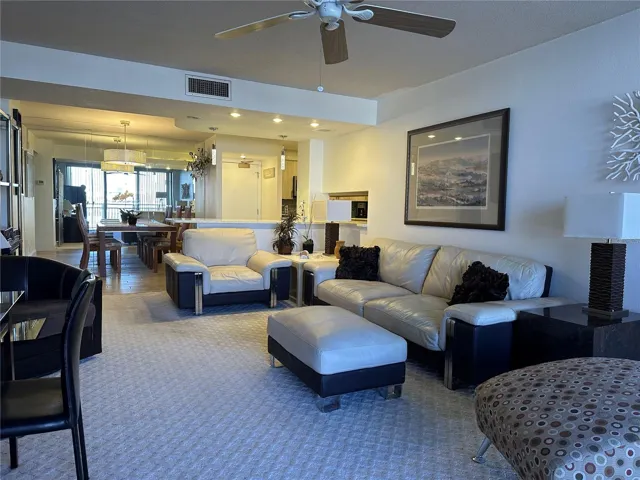 Well-appointed living room featuring comfortable leather furnishings and essential amenities.