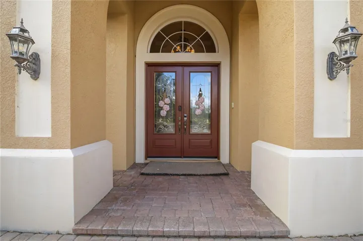 Covered front entry with double doors and classic architectural detail.
