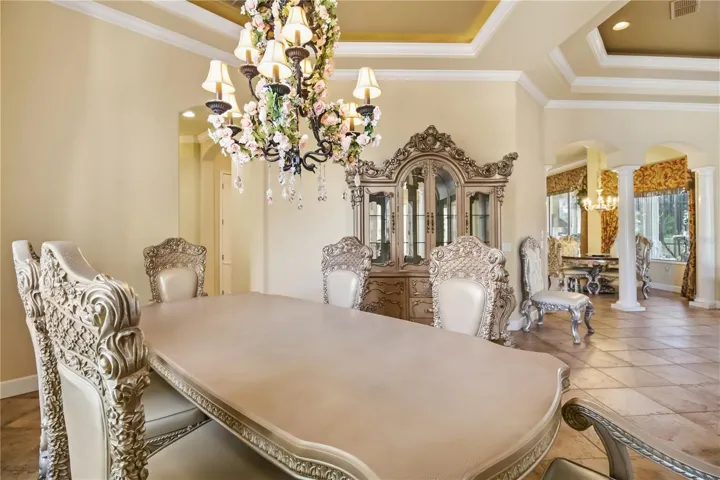 Dining room with chandelier, tray ceiling, and elegant entertaining space.