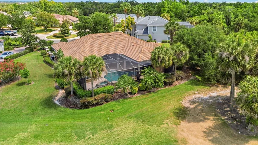 Front aerial view showing the home’s private arrival and mature landscaped setting.