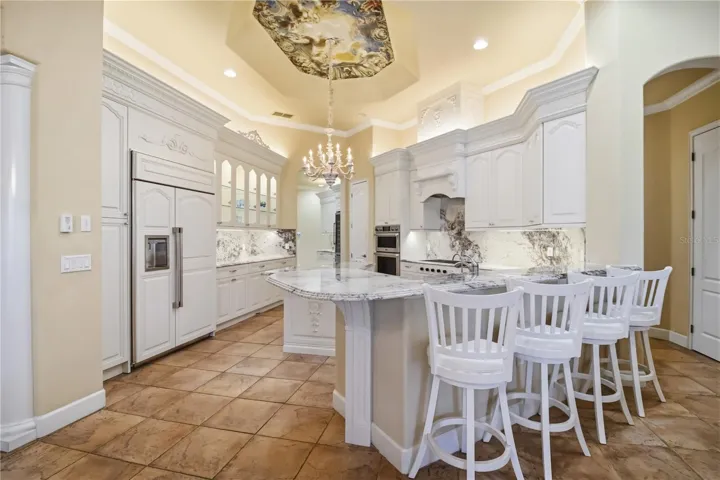 Open kitchen with island seating, pendant lighting, and everyday functionality.